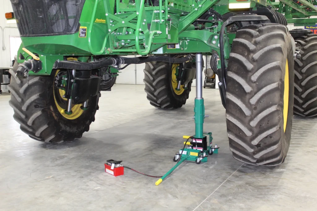 Image of a Model SC-60 Single Cylinder Farm service Jack under combine